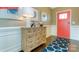 Warm and inviting foyer with stylish decor, a colorful front door, and elegant wood flooring at 116 Fordingbridge Ln, Mooresville, NC 28115