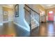 Welcoming foyer showcasing hardwood floors, a staircase with a carpet runner, and an elegant console table at 116 Fordingbridge Ln, Mooresville, NC 28115