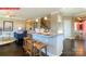 Open-concept kitchen with a breakfast bar and seating, seamlessly connected to the living and dining areas at 116 Fordingbridge Ln, Mooresville, NC 28115