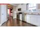 Modern kitchen with white cabinetry, stainless steel appliances, and hardwood flooring at 116 Fordingbridge Ln, Mooresville, NC 28115