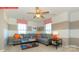 Spacious living room with a grey sofa, neutral walls and two windows with red patterned valances at 116 Fordingbridge Ln, Mooresville, NC 28115