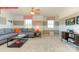 Cozy living room features a comfy grey sofa, two windows and an entertainment console at 116 Fordingbridge Ln, Mooresville, NC 28115