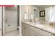 Bathroom features a double vanity with a granite countertop, neutral walls, and a shower-tub combo at 124 Fordingbridge Ln, Mooresville, NC 28115