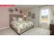 Cozy bedroom with a queen bed, neutral colors, and a large window overlooking a wooded lot at 124 Fordingbridge Ln, Mooresville, NC 28115