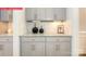 Stylish butler's pantry featuring granite counters, gray cabinets, and ample storage space for hosting at 124 Fordingbridge Ln, Mooresville, NC 28115
