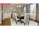 Bright dining area with large windows, elegant lighting, and comfortable seating for enjoyable meals at 124 Fordingbridge Ln, Mooresville, NC 28115