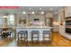 Open-concept kitchen with granite island, seating, stainless appliances, and seamless flow to breakfast area at 124 Fordingbridge Ln, Mooresville, NC 28115