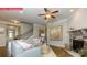 Comfortable living room featuring a stone fireplace, plush seating, and an open staircase at 124 Fordingbridge Ln, Mooresville, NC 28115