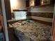 A bedroom inside an RV with a queen bed and window at 128 Twin Bluff Trl # C52, Mount Gilead, NC 27306