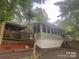 Exterior of home with a sunroom addition and wooden stairs at 128 Twin Bluff Trl # C52, Mount Gilead, NC 27306