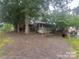 Exterior of home with a grass and gravel yard at 128 Twin Bluff Trl # C52, Mount Gilead, NC 27306
