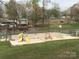 Community playground with slide, swings, jungle gym, and a basketball court for outdoor fun at 128 Twin Bluff Trl # C52, Mount Gilead, NC 27306