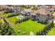 Aerial view showcasing the home's backyard, mature trees, pool and outdoor living space at 1311 Sunnys Halo Ln, Waxhaw, NC 28173