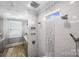 Walk-in shower features white subway tile, custom storage and multi-spray shower head at 1311 Sunnys Halo Ln, Waxhaw, NC 28173