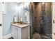 Stylish bathroom features modern vanity, custom mirror and a tiled walk-in shower at 1311 Sunnys Halo Ln, Waxhaw, NC 28173