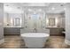 Luxurious bathroom boasting dual vanities, a freestanding tub, and glass enclosed shower at 1311 Sunnys Halo Ln, Waxhaw, NC 28173