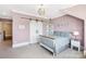 Charming bedroom featuring a decorative light fixture and stylish sliding barn door at 1311 Sunnys Halo Ln, Waxhaw, NC 28173