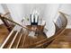 Grand foyer showcases a winding staircase, hardwood floors, and a modern chandelier at 1311 Sunnys Halo Ln, Waxhaw, NC 28173