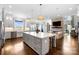 Spacious open kitchen with center island, modern lighting, and seamless flow to living area at 1311 Sunnys Halo Ln, Waxhaw, NC 28173