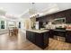 Modern kitchen with stainless steel appliances, an island, and an adjacent dining area at 1311 Sunnys Halo Ln, Waxhaw, NC 28173