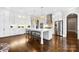 Open kitchen featuring custom cabinets, a large island with seating, and stainless steel appliances at 1311 Sunnys Halo Ln, Waxhaw, NC 28173