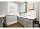 Well-organized laundry room with ample counter space and storage cabinets, simplifying chores at 1311 Sunnys Halo Ln, Waxhaw, NC 28173