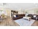 Spacious living room with a large leather couch and access to the kitchen at 1311 Sunnys Halo Ln, Waxhaw, NC 28173
