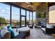 Inviting screened porch with stone fireplace, comfortable seating and wooded views at 1311 Sunnys Halo Ln, Waxhaw, NC 28173