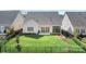 Aerial view of a well-maintained yard featuring green grass and a black fence at 14015 Cameryn Elise Dr, Cornelius, NC 28031