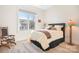 Bright bedroom with a rocking chair, large window view, and vibrant bedside lighting at 14015 Cameryn Elise Dr, Cornelius, NC 28031