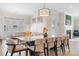 Bright, open-concept dining room and living room featuring modern lighting and neutral tones at 14015 Cameryn Elise Dr, Cornelius, NC 28031
