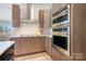 Modern kitchen featuring stainless steel appliances, granite countertops, and ample cabinet space at 14015 Cameryn Elise Dr, Cornelius, NC 28031