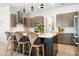 Modern kitchen island with granite countertop, stainless steel appliances, and stylish pendant lights at 14015 Cameryn Elise Dr, Cornelius, NC 28031