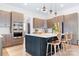 Well-lit kitchen with stainless steel appliances, granite countertops, and a spacious island with bar seating at 14015 Cameryn Elise Dr, Cornelius, NC 28031