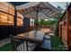 Outdoor dining area on the patio, featuring an umbrella-covered table and a serene atmosphere at 1505 Landis Ave, Charlotte, NC 28205