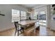 Dining room with wooden table, bench seating, and large windows overlooking the outdoor space at 1505 Landis Ave, Charlotte, NC 28205