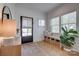 Bright foyer with hardwood floors, a console table, and a bench with storage baskets at 1505 Landis Ave, Charlotte, NC 28205
