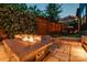 Inviting backyard space featuring an outdoor fire pit, seating, and decorative wall at 1505 Landis Ave, Charlotte, NC 28205