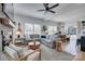 Spacious living room with a large sofa, hardwood floors, and a decorative ceiling fan at 1505 Landis Ave, Charlotte, NC 28205