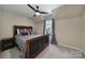 Comfortable bedroom featuring a unique bed frame, ceiling fan, and serene ambiance at 15101 Sharrow Bay Ct # 12, Huntersville, NC 28078