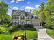 Charming two-story home with a well-manicured lawn, mature trees, and attached garage at 15101 Sharrow Bay Ct # 12, Huntersville, NC 28078
