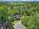 A stunning aerial view of the home situated on a vast, private lot surrounded by lush greenery and mature trees at 15101 Sharrow Bay Ct # 12, Huntersville, NC 28078