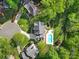 Aerial view of a property with a pool, well-manicured lawn, and surrounding lush greenery at 15101 Sharrow Bay Ct # 12, Huntersville, NC 28078