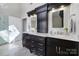 Bathroom with double vanity, marble countertop, and decorative mirrors at 15101 Sharrow Bay Ct # 12, Huntersville, NC 28078