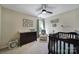 Spacious Bedroom featuring a crib, changing table, armchair, and overhead fan at 15101 Sharrow Bay Ct # 12, Huntersville, NC 28078