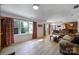 Open-concept living room featuring hardwood floors and connecting to bar and dining area at 15101 Sharrow Bay Ct # 12, Huntersville, NC 28078
