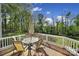 Outdoor deck with table and chairs overlooking lush greenery at 15101 Sharrow Bay Ct # 12, Huntersville, NC 28078