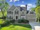 Charming two-story home with a manicured lawn, dark shutters, and brick stairs leading to the front door at 15101 Sharrow Bay Ct # 12, Huntersville, NC 28078