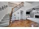 Foyer with hardwood floors, a staircase with metal accents, and view of the living room at 15101 Sharrow Bay Ct # 12, Huntersville, NC 28078