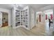 Hallway featuring custom built-in shelving and light-colored floors at 15101 Sharrow Bay Ct # 12, Huntersville, NC 28078